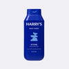 Blue bottle of Harry's body wash on a light gray background